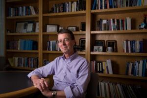 Image of Greg Duncan in front of a bookcase
