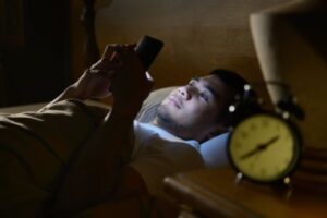 A person on their phone in bed