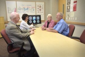 Two unidentified study participants with the UCI MIND Alzheimer’s Disease Research Center meet with UC Irvine researchers, at left, Dr. Malcolm Dick and Dr. Gaby Thai.