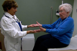 An elderly woman is examined by a doctor at a checkup