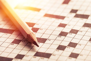 Image of a pencil on a crossword puzzle