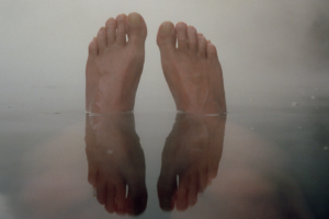 Image of an individuals feet in a bathtub.