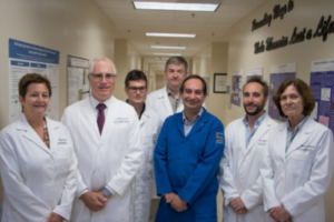 Image of medical doctors posing in a hallway.