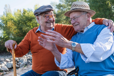 Image of two male seniors talking.