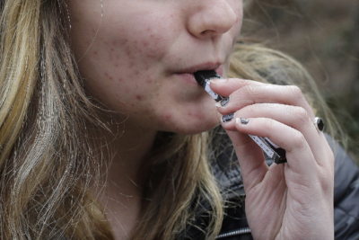 Picture of an adolescent female vaping.