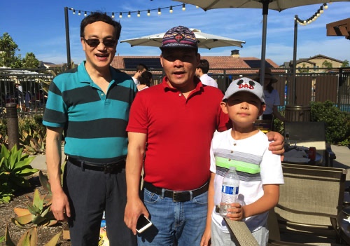 Doctors Guo and Xu pose for a photo with Dr. Xu’s son at a lab party in 2019.
