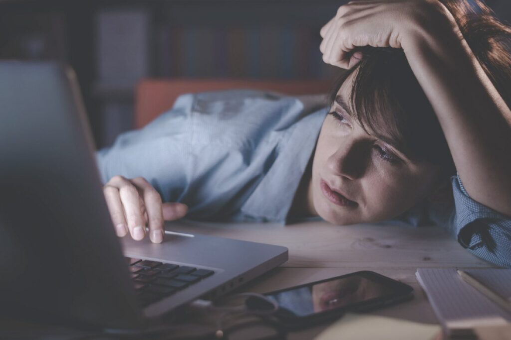 Image of stressed person on computer