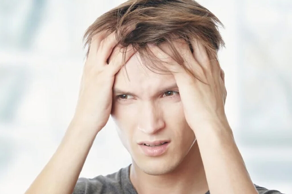 Image of frustrated boy with hands in hair