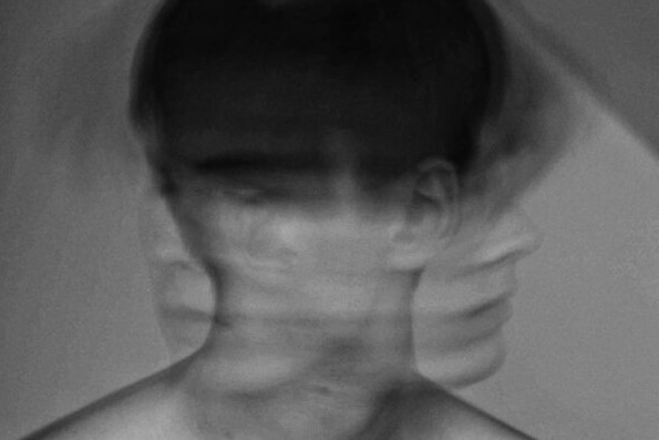 Long exposure image of man shaking head left to right. Natural disasters linked to increased mental health problems.