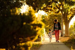 Mother walking with child. Predictable and consistent parental behavior is key for optimal child brain development.