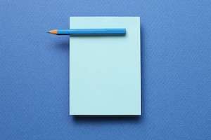 A blue notepad with a blue pencil on a light blue background