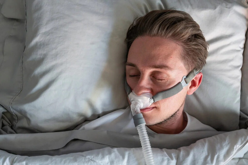 person sleeping with sleep apnea