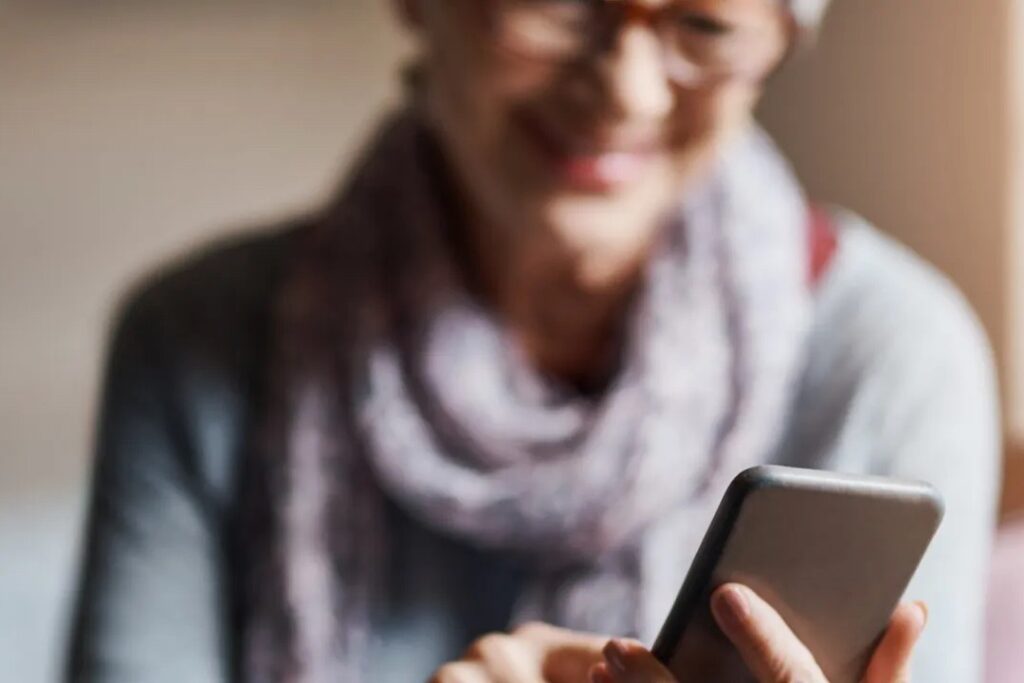 Blurred image of woman tapping on phone
